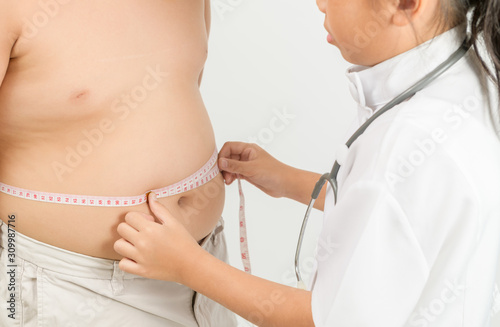Little doctor measuring obese child waist body fat isolated