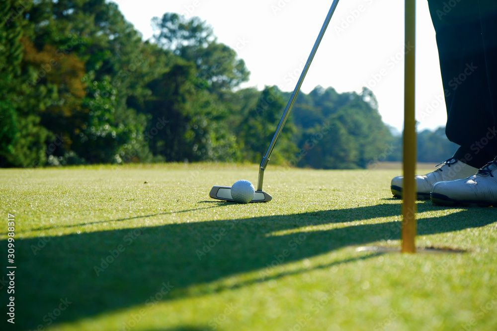 Obraz premium Golfer playing golf in beautiful golf course in the evening golf course with sunshine
