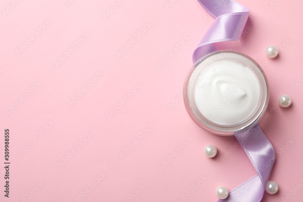 Jar of winter cream for skin on pink background, space for text. Top view