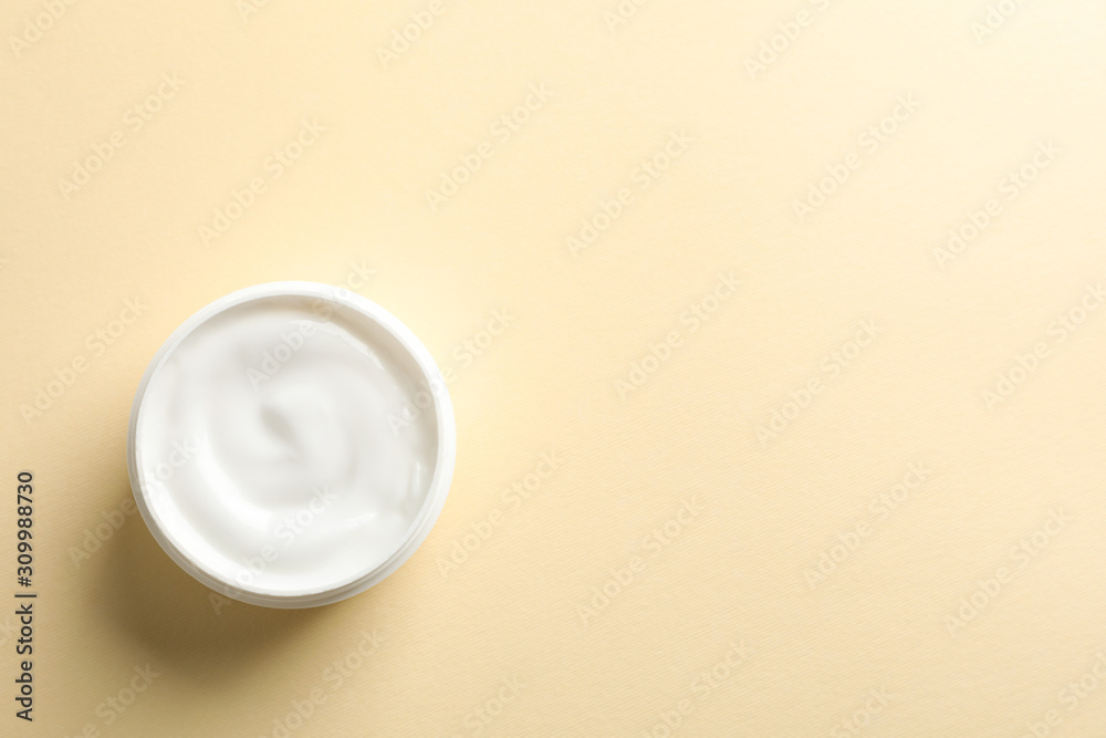 Jar of winter cream for skin on yellow background, space for text. Top view Jar of winter cream for skin on yellow background, space for text. Top view