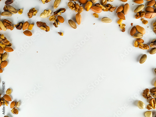 Healthy and nutritious organic nut mix presenting a healthy diet out on the corners of the image forming a frame with empty white space underneath