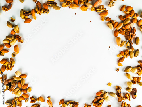 Healthy and nutritious organic colorful nut mix presenting a healthy diet out on the corners of the image forming a circle to fill