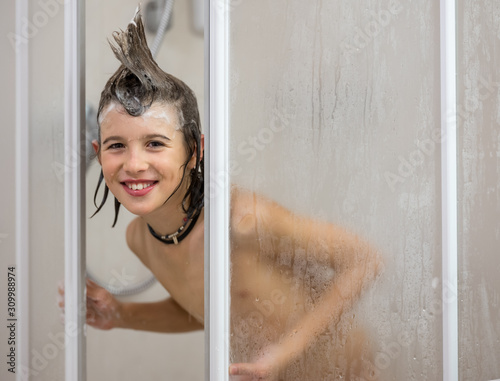 The boy has fun in the shower photo