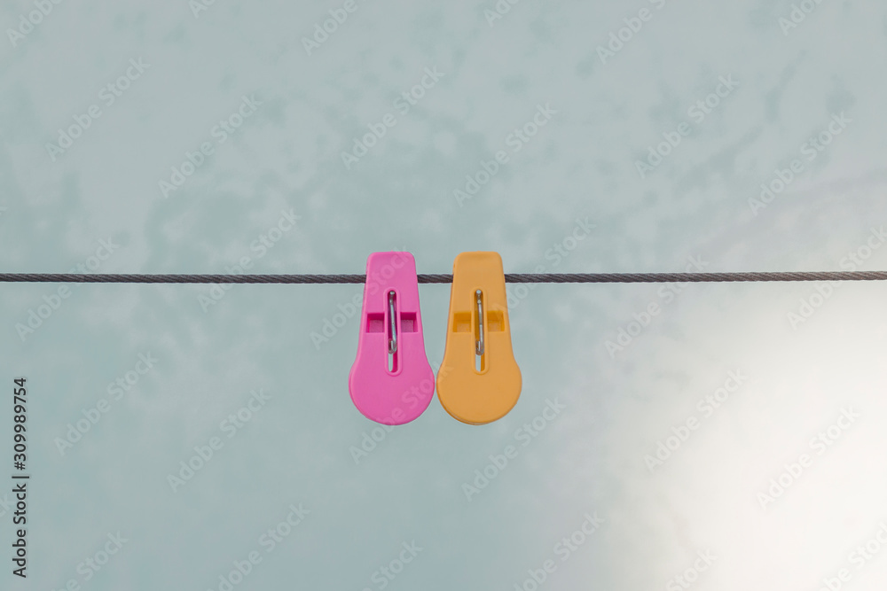plastic clothespins pink and yellow color on wall background plastic clothespins pink and yellow color on wall background