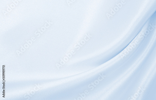 Smooth elegant blue silk or satin luxury cloth texture as abstract background. Luxurious background design photo