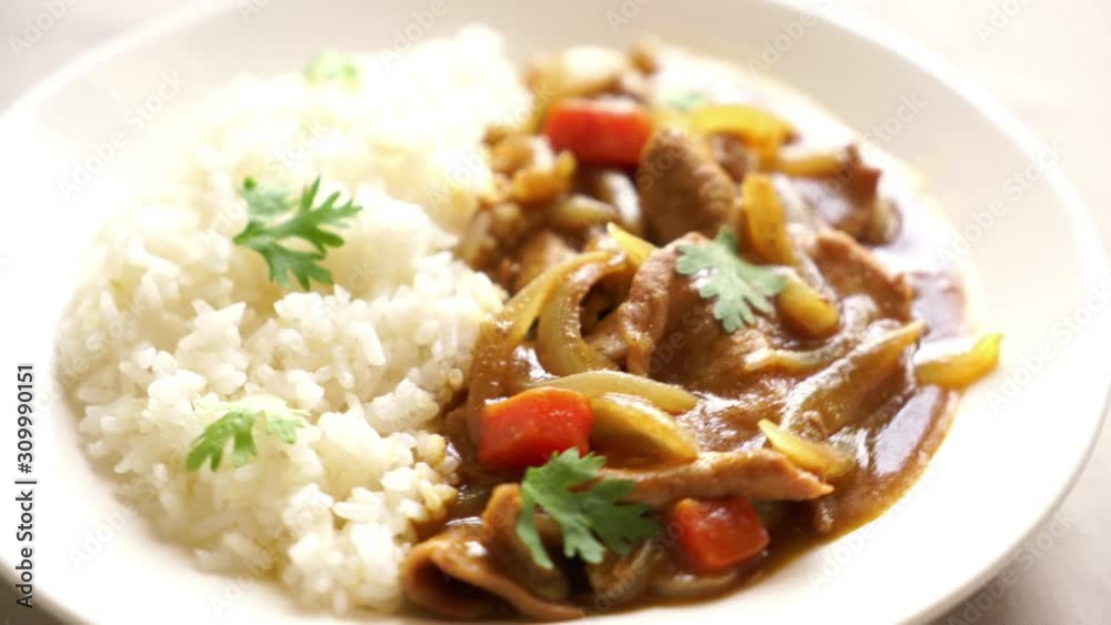 Japanese curry rice with sliced pork, carrot and onions Japanese curry rice with sliced pork, carrot and onions