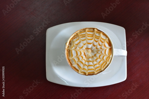Hot coffee of Cappuccino with latte art on wooden table background. Top view with copy space for text or objects.