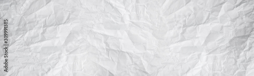 wide panorama white and gray crumpled paper texture background. crush paper so that it becomes creased and wrinkled.