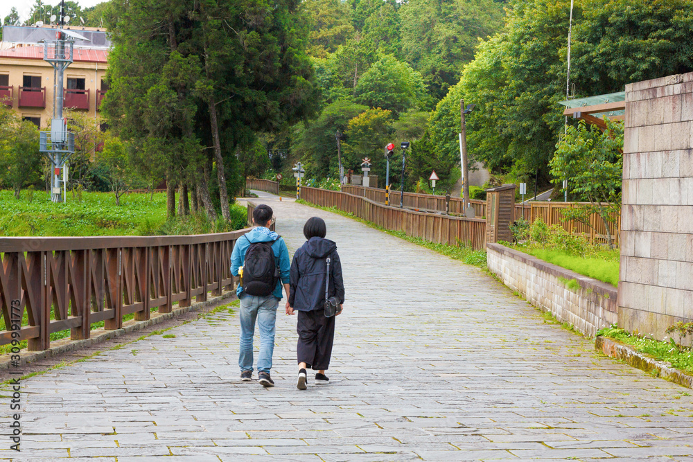 picture of couple holding hands and walking on the road near Alishan train station. Alishan Taiwan picture of couple holding hands and walking on the road near Alishan train station. Alishan Taiwan
