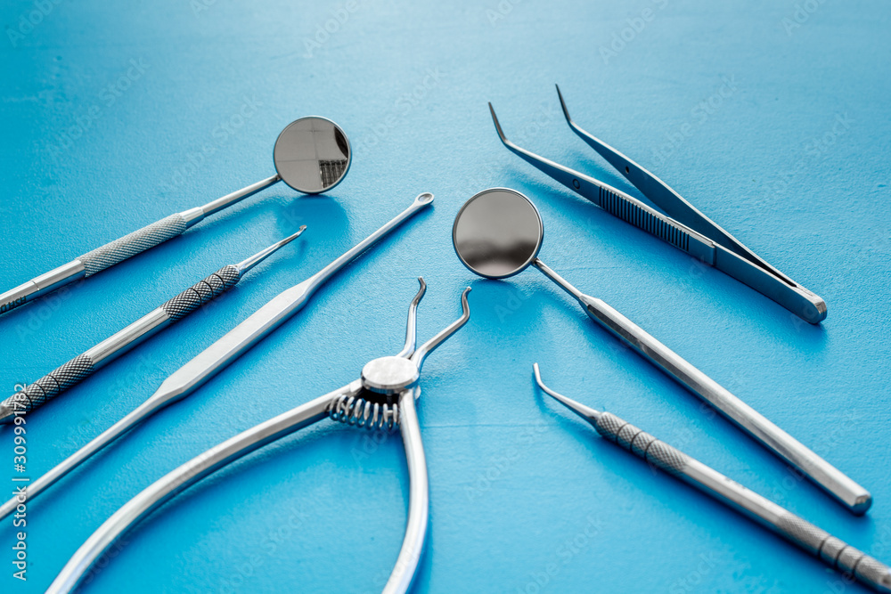Dental instruments - set with mirrors - on blue background close up Dental instruments - set with mirrors - on blue background close up
