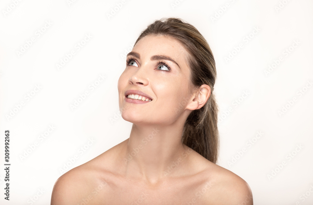 portrait of young woman with perfect skin smiling and loking up portrait of young woman with perfect skin smiling and loking up