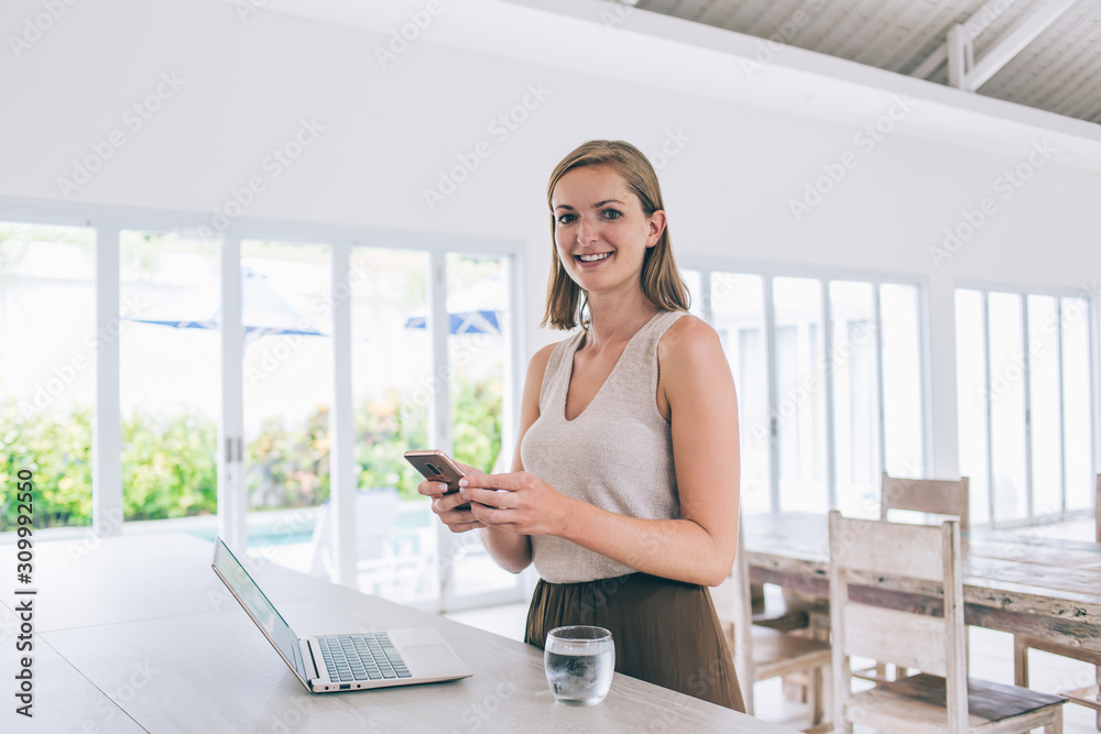 Attractive freelancer woman using phone at work space Attractive freelancer woman using phone at work space