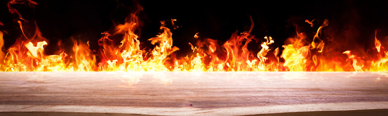 empty wooden with Panorama Fire flames on black background. backdrop. Wood table top. can used for display or montage your products