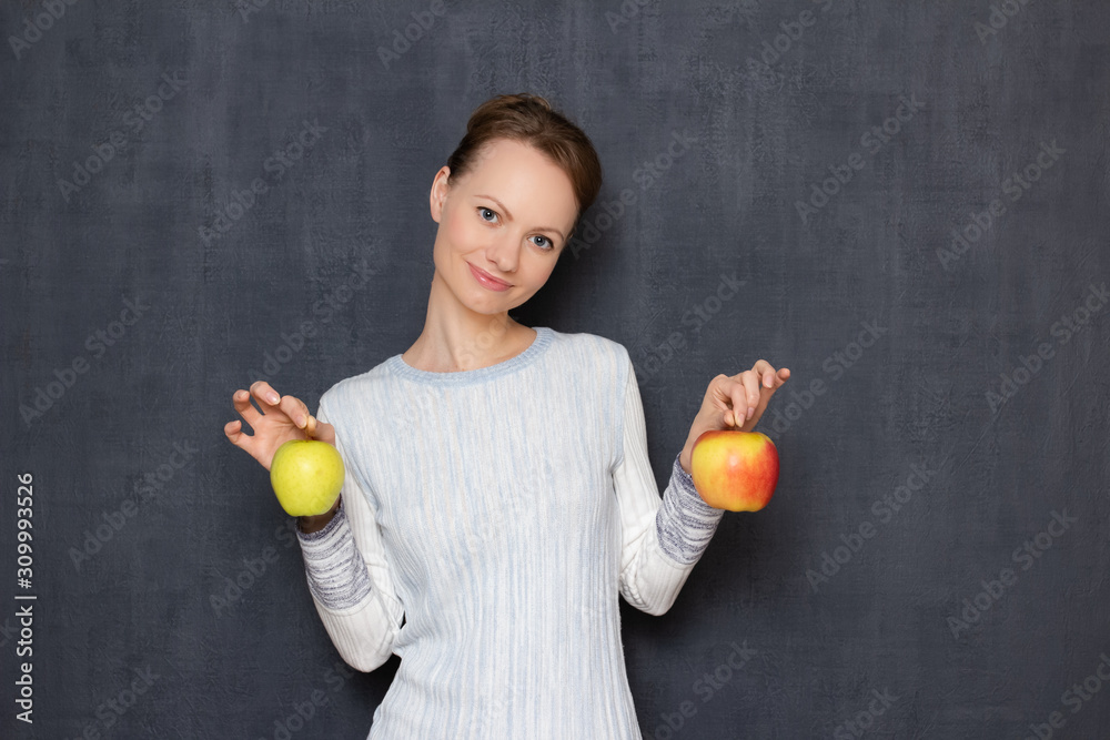 Portrait of happy joyful girl smiling and holding ripe apples in hands Portrait of happy joyful girl smiling and holding ripe apples in hands