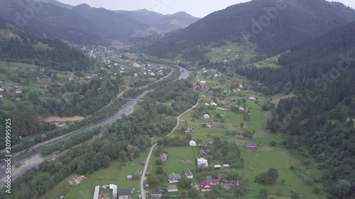 Aerial summer view to river Black Cheremosh in Carpathian village Kryvorivnia, Ukraine Typical landscape in Hutsulshchyna National Park in Ukraine photo