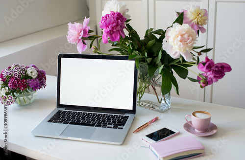 Fototapeta Naklejka Na Ścianę i Meble -  Female office desk workspace homeoffice mock up with laptop, pink peony flowers bouquet, smartphone, pink accessories and pink cup of coffee. Fashion, beauty or lifestyle blog concept.