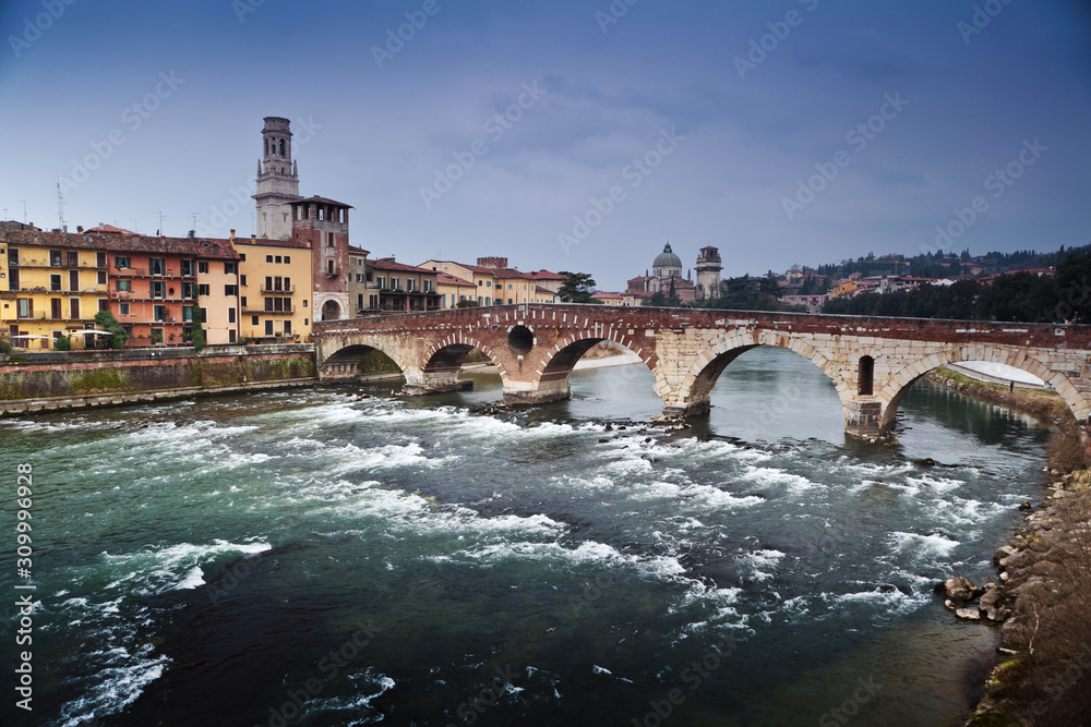 Romantic story in Evening Verona in Italy and a bridge over troubled water Adige River in winter season