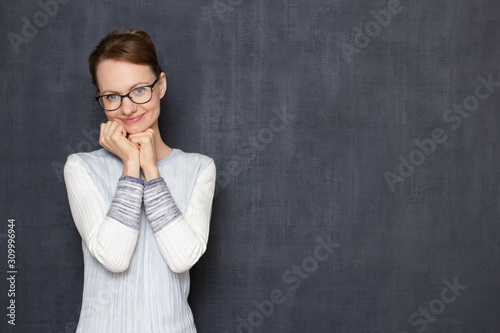 Portrait of happy satisfied young woman being in anticipation