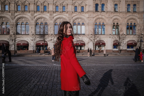 Happy women walking in red coat at the red square in Moscow © YURII Seleznov