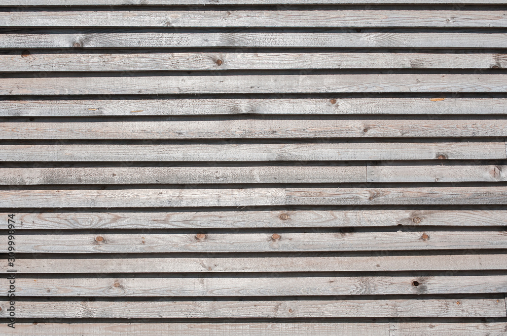 Wooden boards wall with shadows closeup as wooden background Wooden boards wall with shadows closeup as wooden background