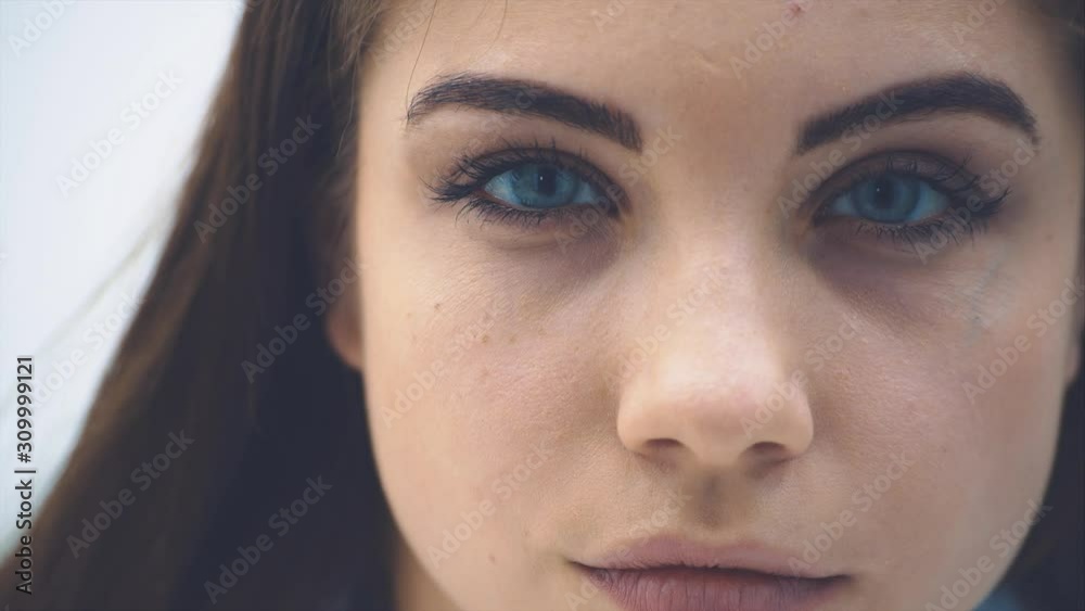 Cropped face of cute female doctor looking at the camera with piercing look, beautiful deep blue eyes. Cropped face of cute female doctor looking at the camera with piercing look, beautiful deep blue eyes.