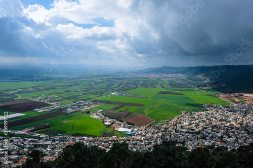 Panoramic view to green walley with the town
