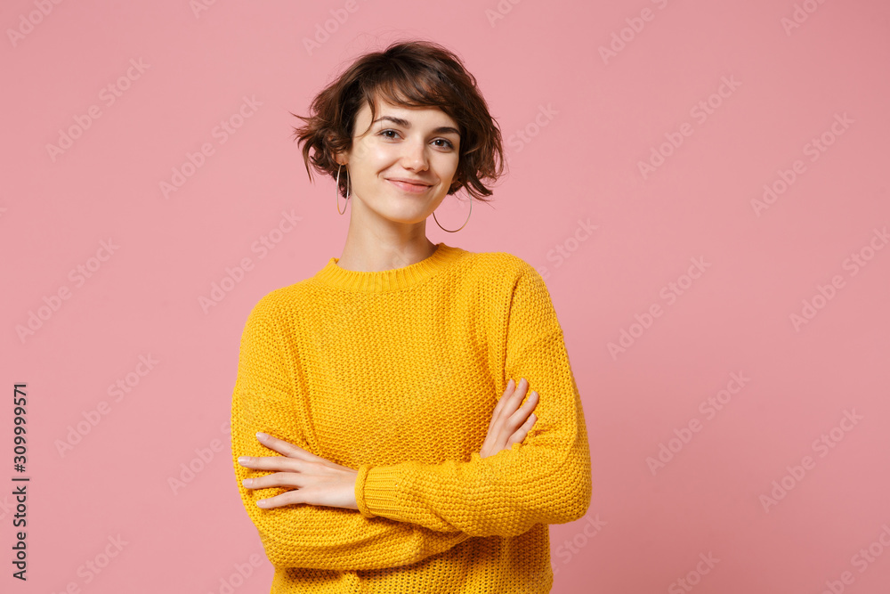 Smiling young brunette woman girl in yellow sweater posing isolated on ...