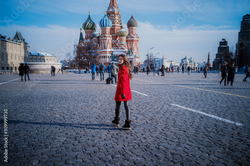 Photography Happy women walking in red coat at the red square in Moscow