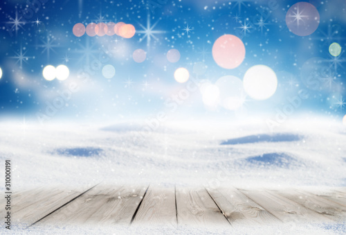 Decorative Christmas background with winter snowy blurred bokeh flakes of snow fall and empty wooden flooring © Aleksei