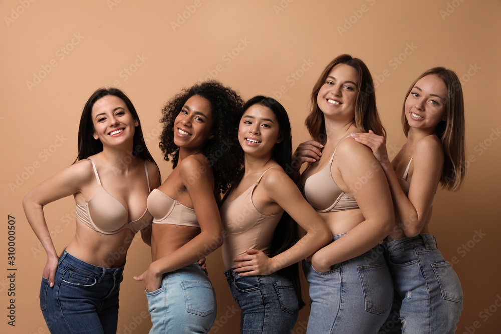 Group of women with different body types in jeans and underwear on beige  background Photos | Adobe Stock