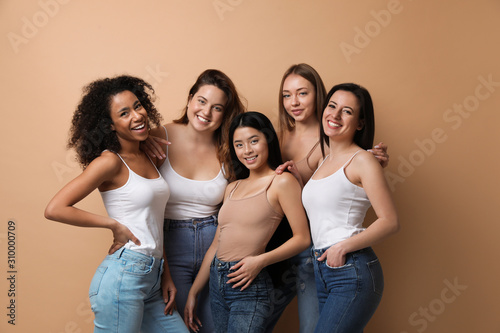 Group of women with different body types on beige background
