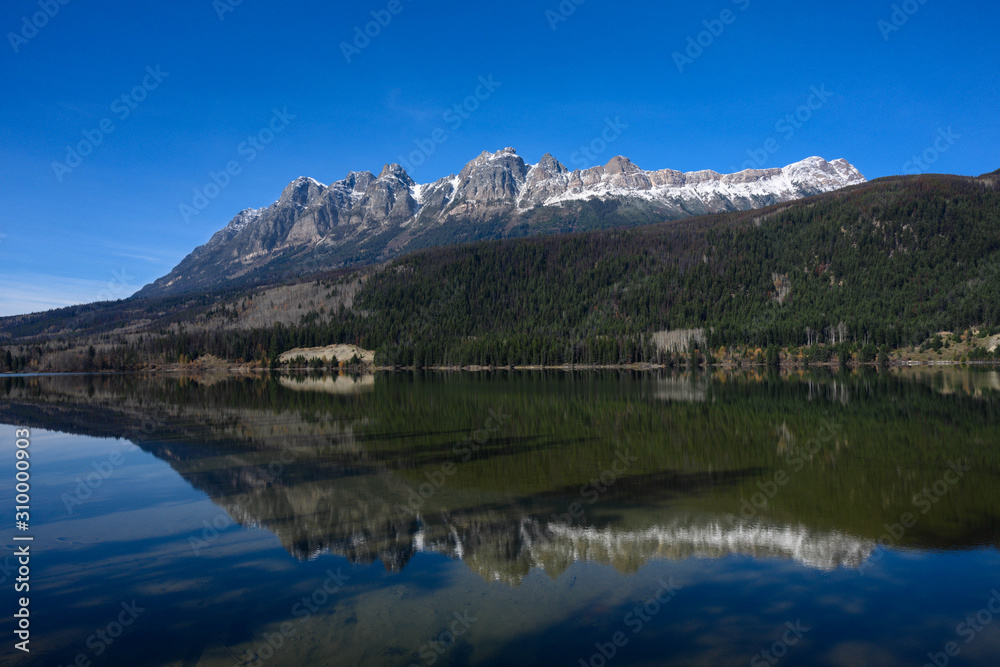 Mirror photography of the Canadian Rockies at Mount Fitzwilliam depicting landscape with crystal clear water reflection in pure natural lake waters