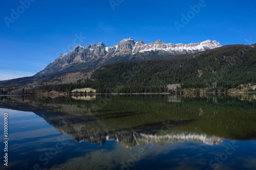Mirror photography of the Canadian Rockies at Mount Fitzwilliam depicting landscape with crystal clear water reflection in pure natural lake waters