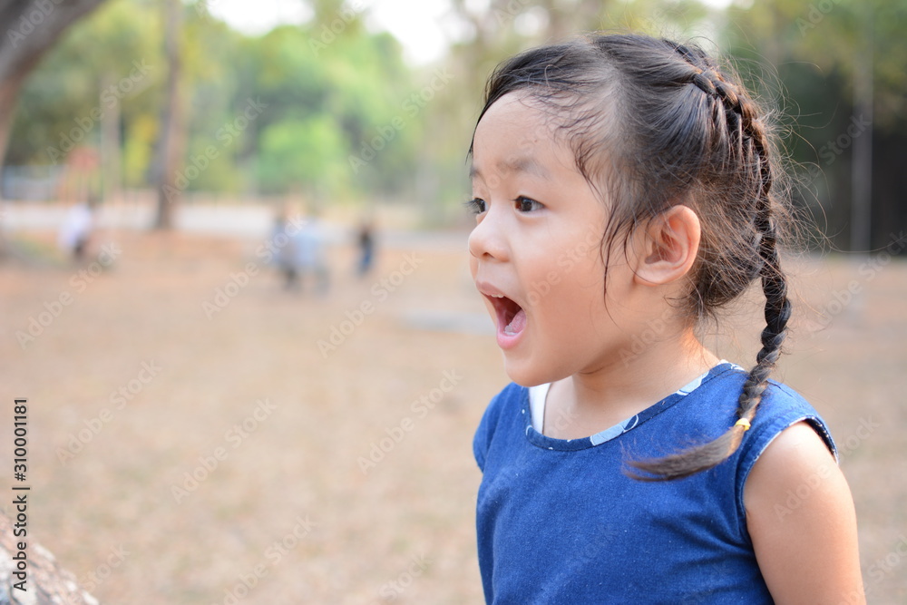Blurred little Asian girl shouting, the background is the park. Blurred little Asian girl shouting, the background is the park.
