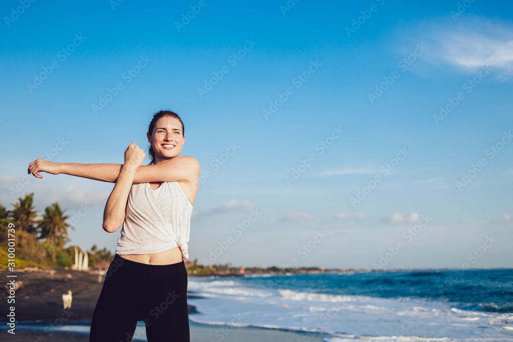 Healthy happy woman doing warm up at seaside Healthy happy woman doing warm up at seaside