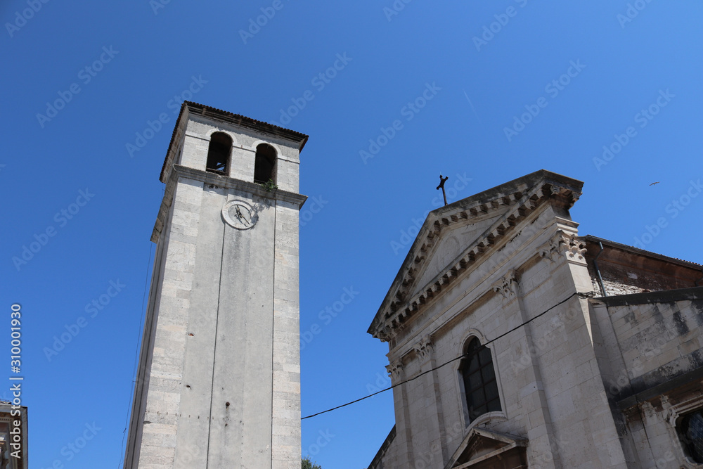 a clocktower from a church at summer