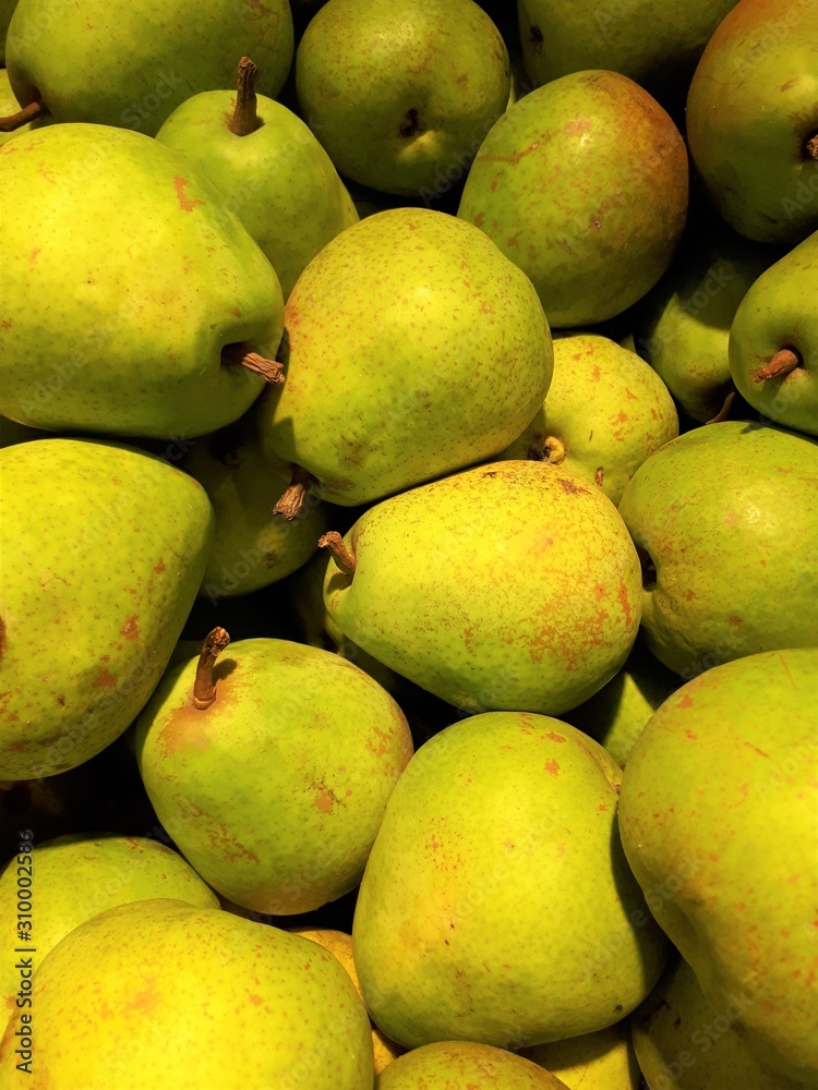close-up of fruit, fresh ripe uncooked flavorful sweet yellow pears in a store close-up of fruit, fresh ripe uncooked flavorful sweet yellow pears in a store