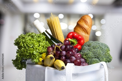 Full shopping bag with vegetable on blur background