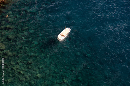 Single boat in the sea off the coast, top view © Yury Kirillov
