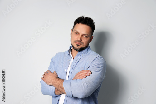 Portrait of handsome man on light grey background