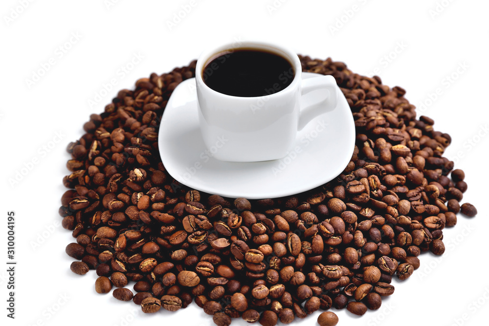 white cup of coffee on a white saucer stands on a hill of coffee beans on a white background angle view from above white cup of coffee on a white saucer stands on a hill of coffee beans on a white background angle view from above