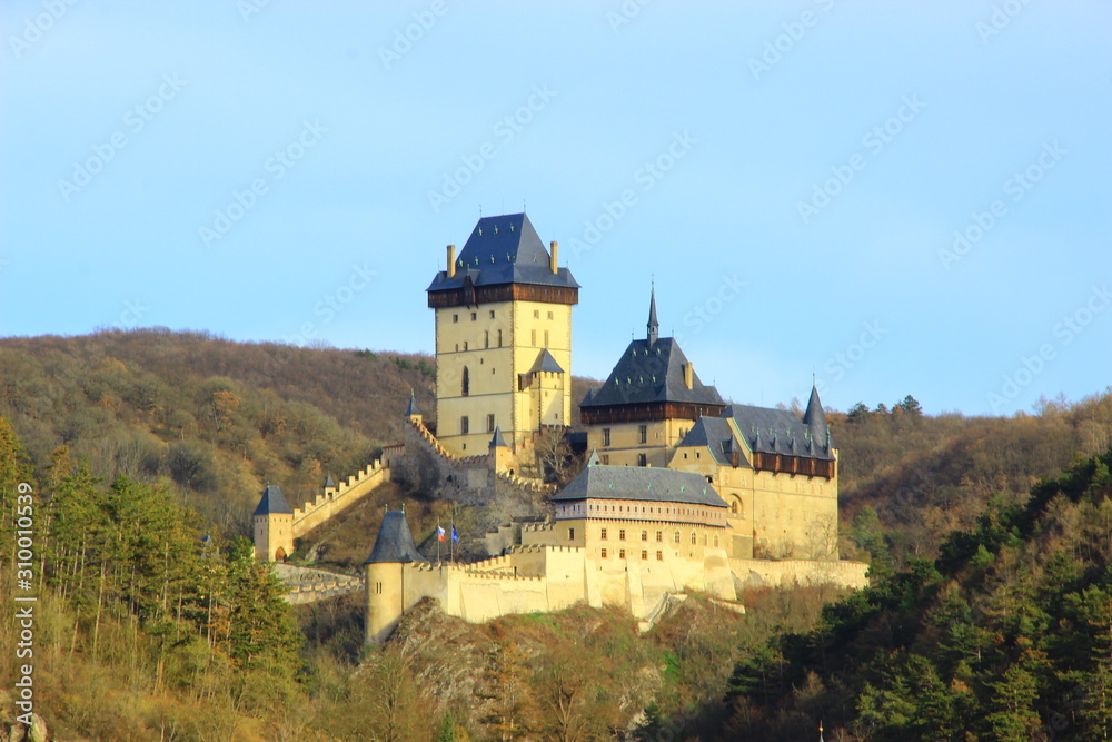 Karlstejn is a medieval castle on the slopes of a high cliff