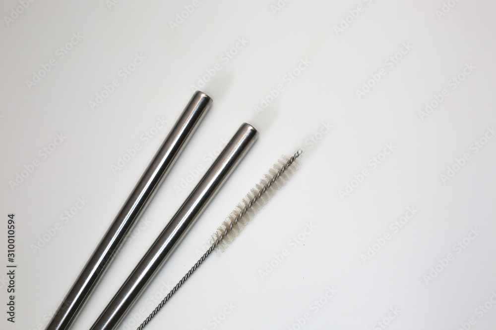 Stainless metallic straws to drink juice and brush to clean. Zero waste concept. Stainless metallic straws to drink juice and brush to clean. Zero waste concept.