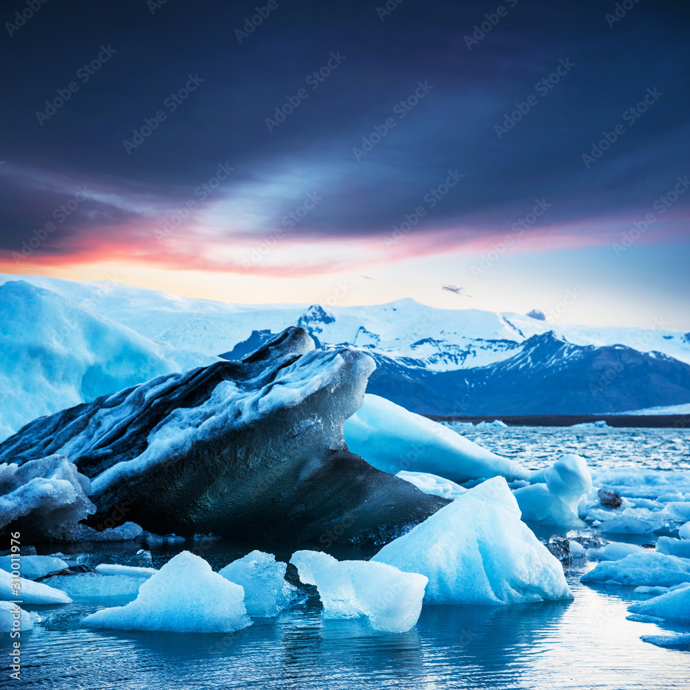 Magical beautiful landscape with ice depths in the famous Jokulsarlon glacial lagoon in Iceland at dawn. Exotic countries. Amazing places. Popular tourist atraction. (global warming – concept)