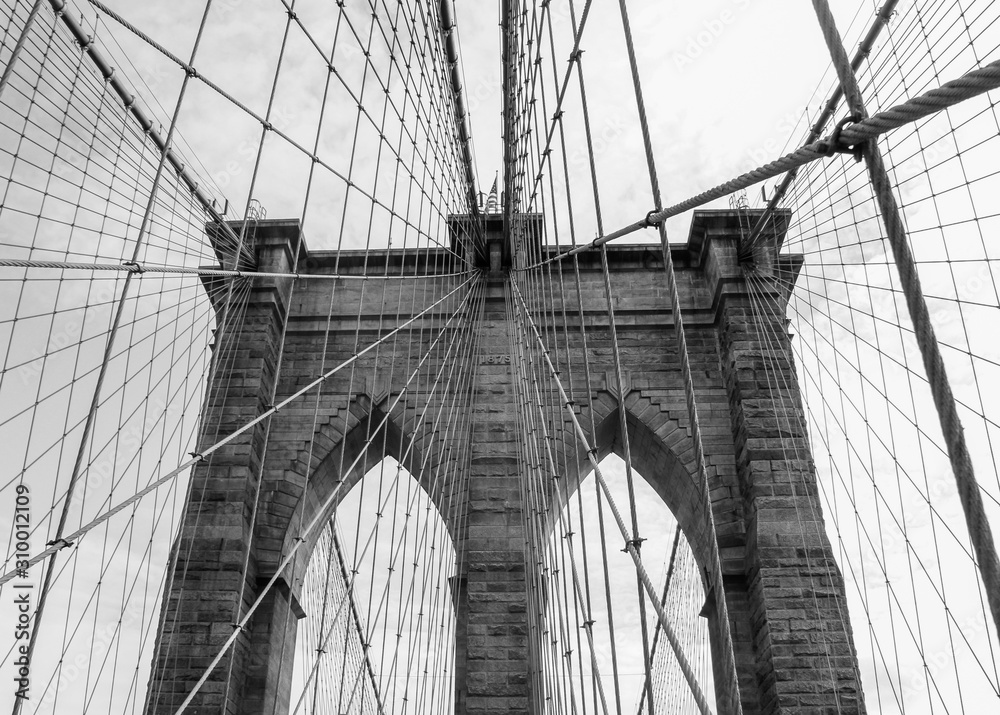 Fototapeta premium Close up of Brooklyn Bridge in New York City in black and white