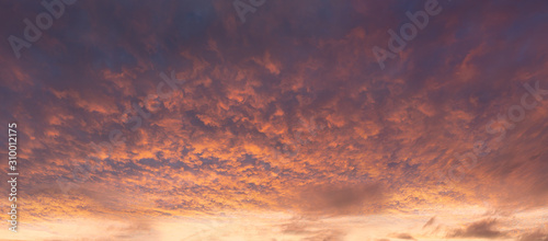 panorama of dramatic cloudscape at sunset with red clouds on sky