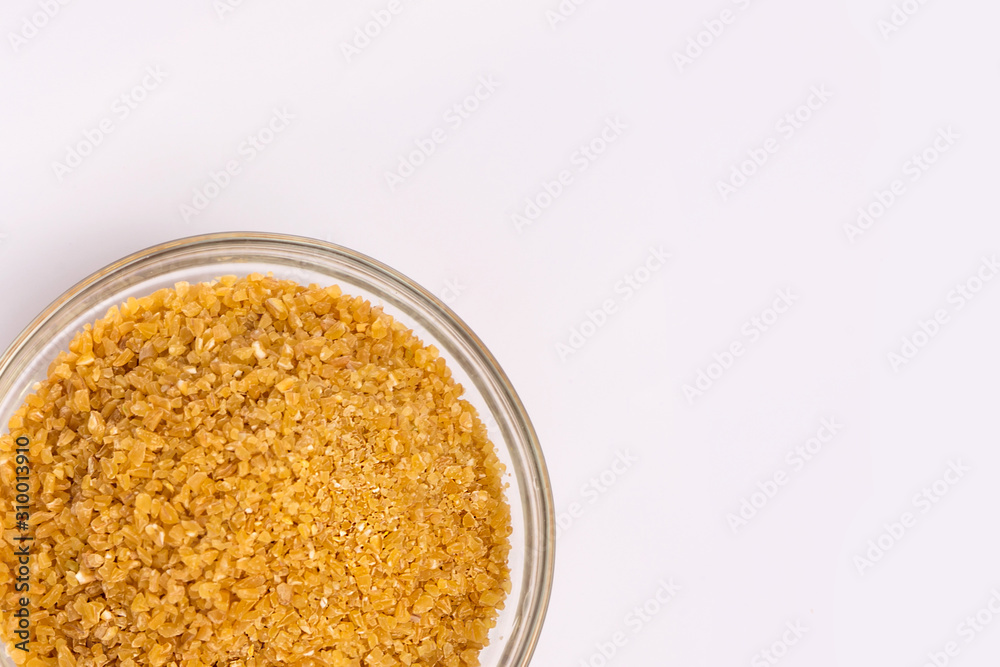 Wheat groats in a plate on a white background. Groats in a small plate. Healthy breakfast on a white background. Wheat groats in a plate on a white background. Groats in a small plate. Healthy breakfast on a white background.