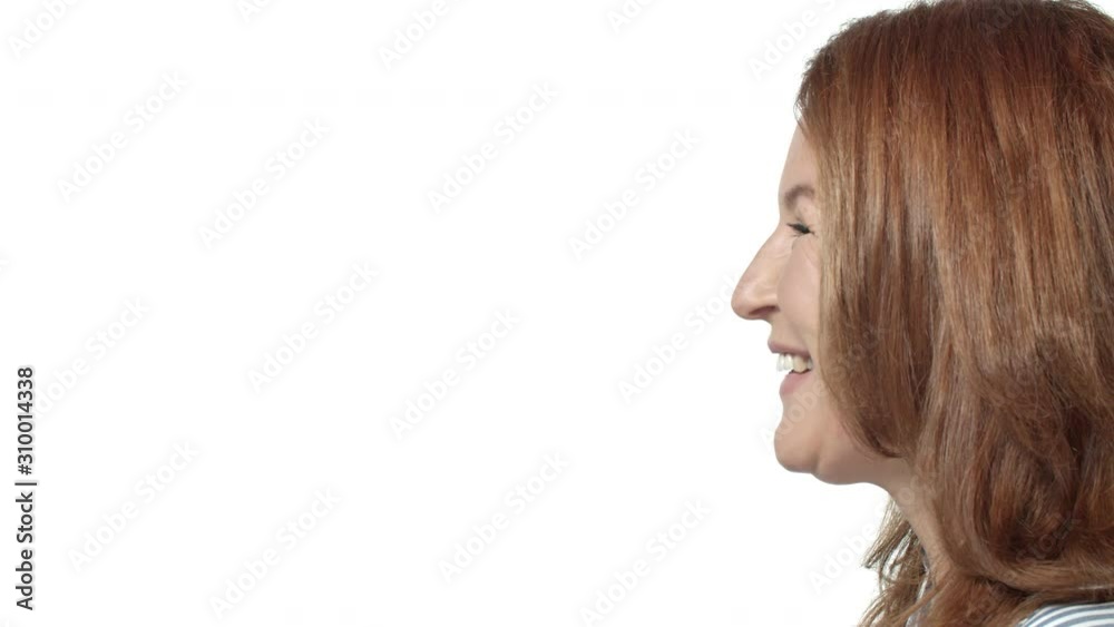 Slow-motion, close-up profile shot woman looking left, standing white background, start smiling and laughing with lovely, happy expression, enjoy conversation, spend holidays with family, feel secure Slow-motion, close-up profile shot woman looking left, standing white background, start smiling and laughing with lovely, happy expression, enjoy conversation, spend holidays with family, feel secure