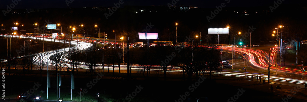 Landscape of the city with blurred lights of car headlamps Landscape of the city with blurred lights of car headlamps