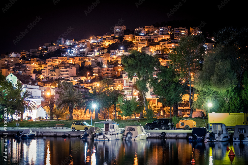 Fototapeta premium Residential houses on the seashore near the bay with boats. Greece.